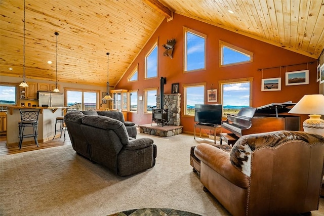 188 June Grass Ct, Fairplay, CO 80440 - living area with a wooden ceiling with exposed beams, high vaulted ceiling, a wood stove, plenty of natural light, and recessed lighting