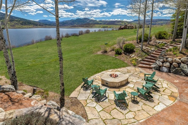 32855 More Ln, Steamboat Springs, CO 80487 - view of green lawn with an outdoor fire pit, a patio, and a water and mountain view