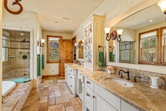 32855 More Ln, Steamboat Springs, CO 80487 - bathroom with healthy amount of natural light, stone tile floors, a stall shower, and double vanity