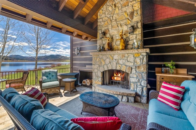 32855 More Ln, Steamboat Springs, CO 80487 - living area featuring an outdoor stone fireplace, a water view, and wood ceiling