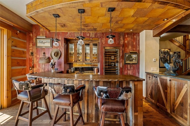 32855 More Ln, Steamboat Springs, CO 80487 - indoor wet bar with wood walls, wine cooler, stairway, and hanging light fixtures