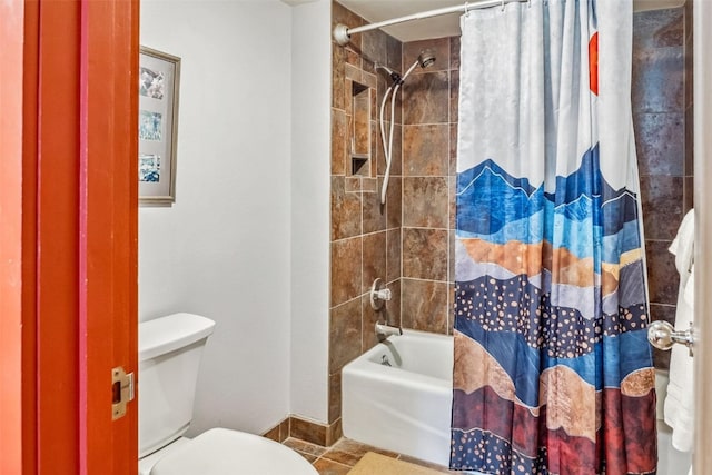 bathroom featuring shower / tub combo, tile patterned floors, baseboards, and toilet