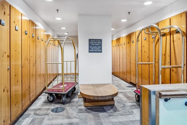 interior space with recessed lighting, carpet flooring, and wood walls