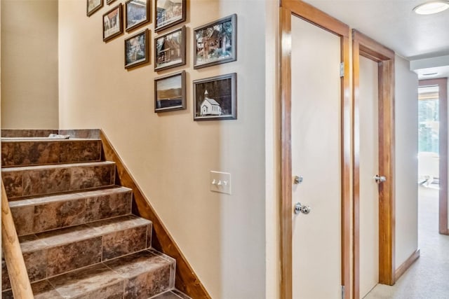 stairway featuring baseboards