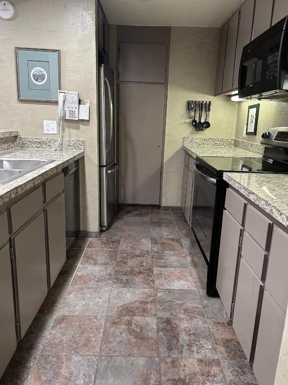 22340 US Highway 6 Unit 1788, Keystone, CO 80435 - kitchen featuring black appliances, stone finish floors, light countertops, and a textured wall