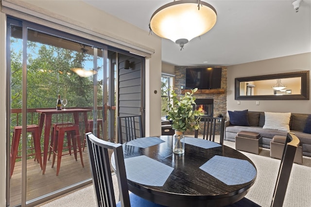 100 S Park Ave Unit E321, Breckenridge, CO 80424 - dining area with a stone fireplace and wood finished floors