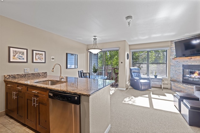 100 S Park Ave Unit E321, Breckenridge, CO 80424 - kitchen featuring dishwasher, open floor plan, stone countertops, a stone fireplace, and decorative light fixtures