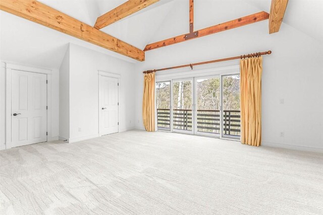 31820 Bradley Rnch, Steamboat Springs, CO 80487 - unfurnished bedroom with access to exterior, beamed ceiling, carpet floors, baseboards, and high vaulted ceiling