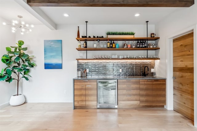 427 Whispering Pines Cir, Blue River, CO 80424 - indoor wet bar with wine cooler, light wood finished floors, beam ceiling, a chandelier, and baseboards