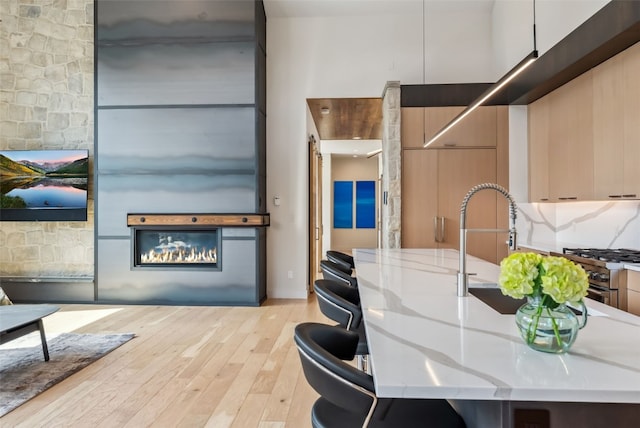 427 Whispering Pines Cir, Blue River, CO 80424 - dining area featuring light wood-type flooring and a glass covered fireplace