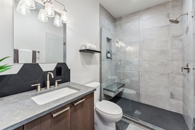 427 Whispering Pines Cir, Blue River, CO 80424 - full bathroom featuring toilet, tiled shower, and vanity