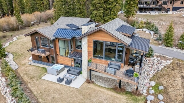 427 Whispering Pines Cir, Blue River, CO 80424 - rear view of property with a standing seam roof, metal roof, outdoor lounge area, and a patio