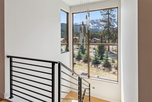 427 Whispering Pines Cir, Blue River, CO 80424 - stairs with plenty of natural light, a mountain view, and wood finished floors