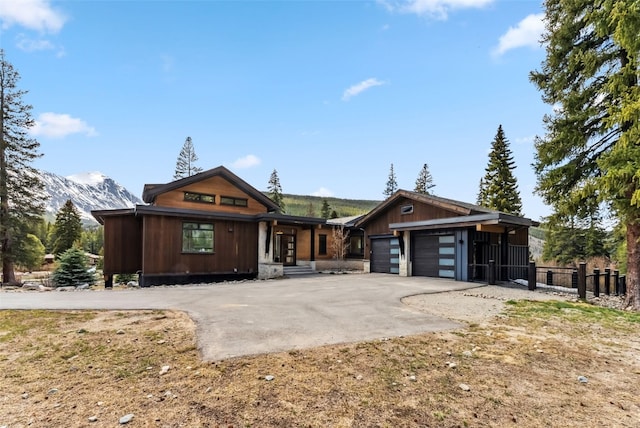 427 Whispering Pines Cir, Blue River, CO 80424 - view of front of house featuring asphalt driveway, a mountain view, and a garage