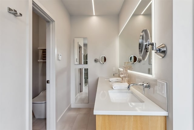 427 Whispering Pines Cir, Blue River, CO 80424 - bathroom featuring toilet, tile patterned floors, double vanity, and baseboards