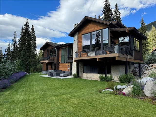 427 Whispering Pines Cir, Blue River, CO 80424 - rear view of property featuring an outdoor hangout area, a lawn, a balcony, and a chimney