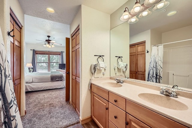 22714 US Highway 6 Unit 5945, Keystone, CO 80435 - bathroom featuring connected bathroom, double vanity, a ceiling fan, a shower with curtain, and a textured ceiling