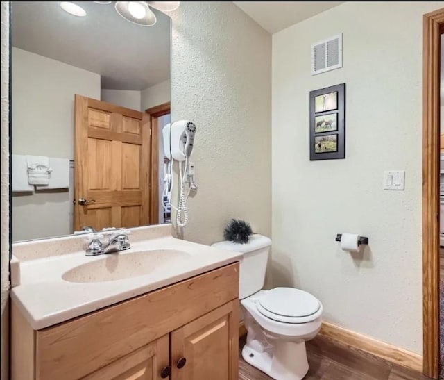 22714 US Highway 6 Unit 5945, Keystone, CO 80435 - half bathroom featuring vanity, wood finished floors, and a textured wall