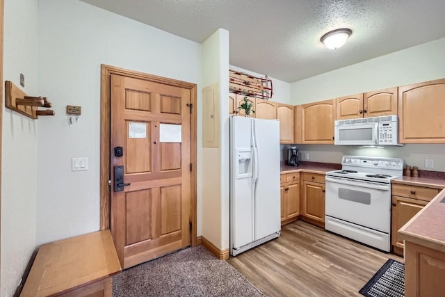 22714 US Highway 6 Unit 5945, Keystone, CO 80435 - kitchen with white appliances, light brown cabinetry, light wood-type flooring, a textured ceiling, and light countertops