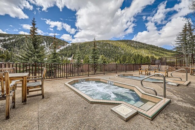 22714 US Highway 6 Unit 5945, Keystone, CO 80435 - view of pool with a mountain view, a patio, an in-ground hot tub, and a wooded view