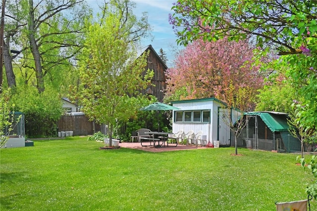 399 E Jefferson Ave, Hayden, CO 81639 - back of property featuring an outdoor structure, a patio, and board and batten siding