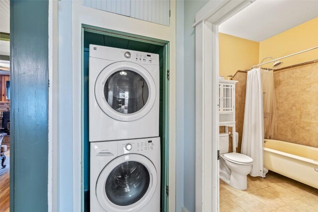399 E Jefferson Ave, Hayden, CO 81639 - laundry area with stacked washing machine and dryer and tile patterned floors