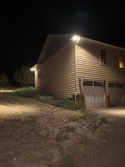 3692 County Road 7, Craig, CO 81625 - property exterior at twilight featuring an attached garage and dirt driveway