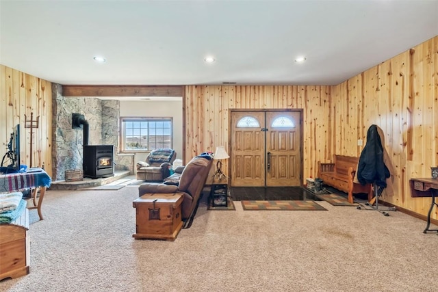 3692 County Road 7, Craig, CO 81625 - living area featuring carpet, a wood stove, wood walls, and recessed lighting