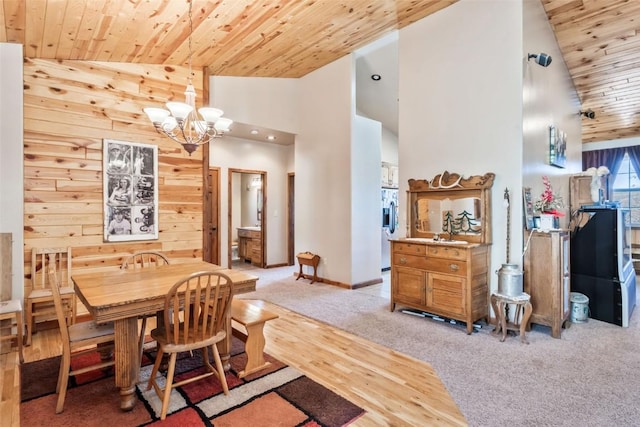 3692 County Road 7, Craig, CO 81625 - dining room with wood ceiling, a chandelier, high vaulted ceiling, baseboards, and light wood-type flooring