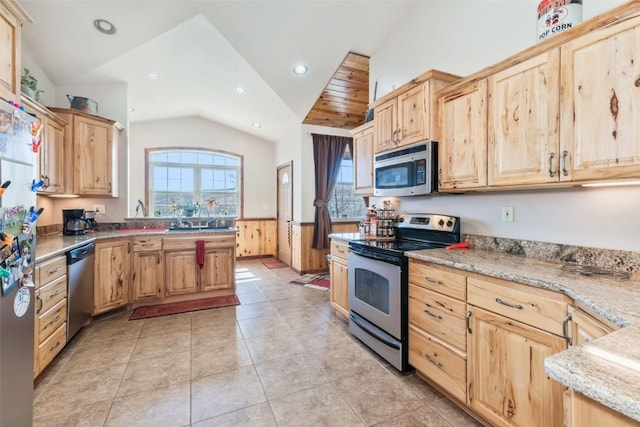 3692 County Road 7, Craig, CO 81625 - kitchen featuring appliances with stainless steel finishes, light brown cabinets, vaulted ceiling, a wainscoted wall, and recessed lighting