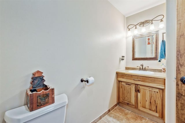 3692 County Road 7, Craig, CO 81625 - half bath featuring toilet, tile patterned flooring, vanity, and baseboards