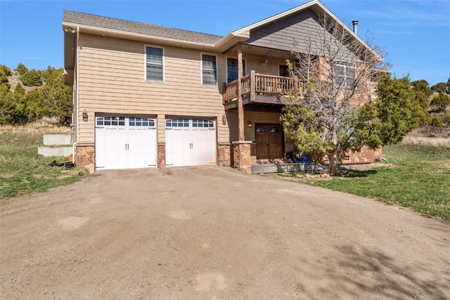 3692 County Road 7, Craig, CO 81625 - view of front facade featuring an attached garage, driveway, a balcony, and stone siding