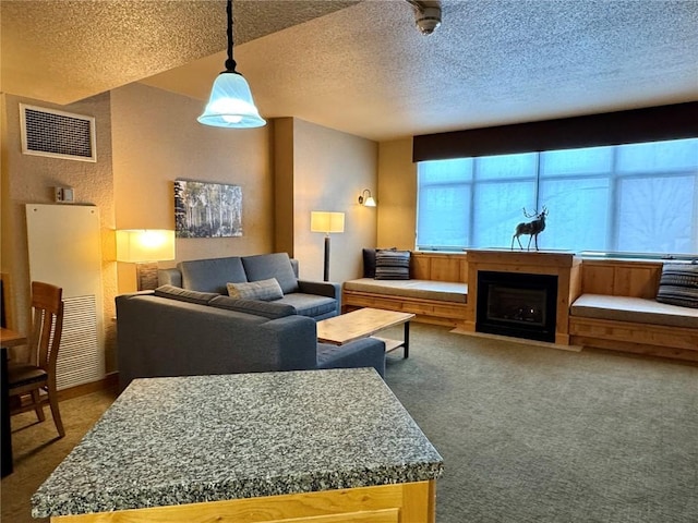 living room featuring a textured ceiling, carpet, and visible vents
