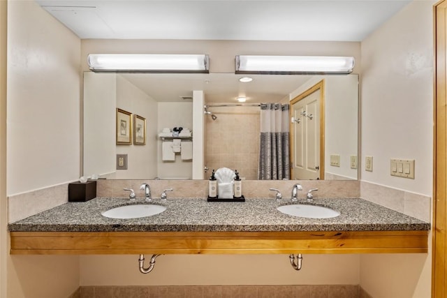 full bathroom featuring a shower with curtain, double vanity, and a sink