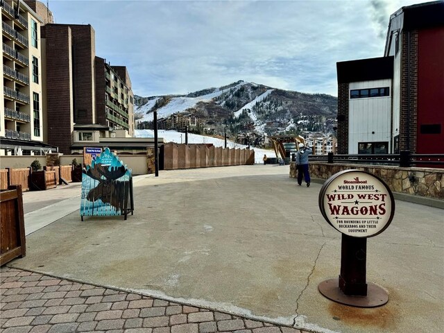 exterior space with a mountain view and fence