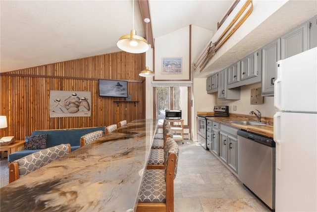 1173 Ski Hill Rd Unit 131, Breckenridge, CO 80424 - kitchen featuring appliances with stainless steel finishes, a sink, gray cabinets, high vaulted ceiling, and light stone finish flooring
