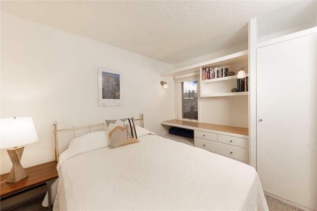 1173 Ski Hill Rd Unit 131, Breckenridge, CO 80424 - bedroom featuring a textured ceiling, carpet flooring, and a baseboard heating unit
