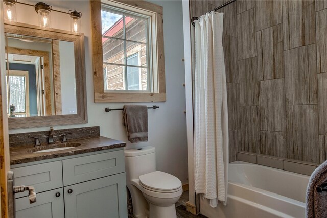 full bath featuring shower / bath combo, toilet, and vanity