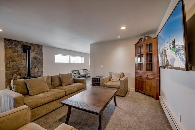 living room featuring a baseboard radiator, a wood stove, light carpet, and recessed lighting
