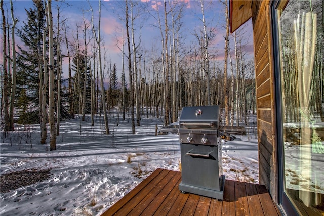 snow covered deck featuring grilling area