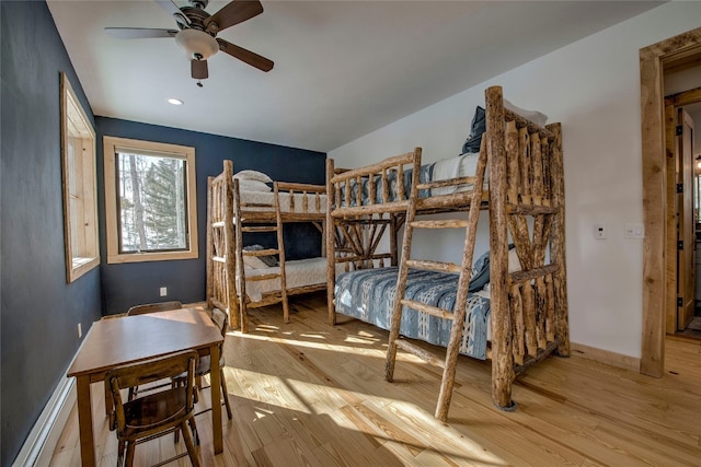 bedroom with recessed lighting, wood finished floors, and baseboards