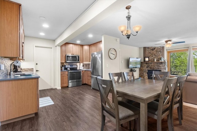 2350 Ski Trail Ln Unit 313, Steamboat Springs, CO 80487 - dining room with a fireplace, ceiling fan, dark wood-style flooring, and recessed lighting