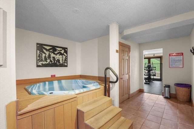2350 Ski Trail Ln Unit 313, Steamboat Springs, CO 80487 - kitchen featuring light tile patterned floors, light countertops, light brown cabinets, baseboards, and a textured ceiling