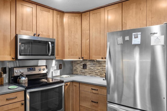 2350 Ski Trail Ln Unit 313, Steamboat Springs, CO 80487 - kitchen featuring stainless steel appliances, decorative backsplash, and light countertops