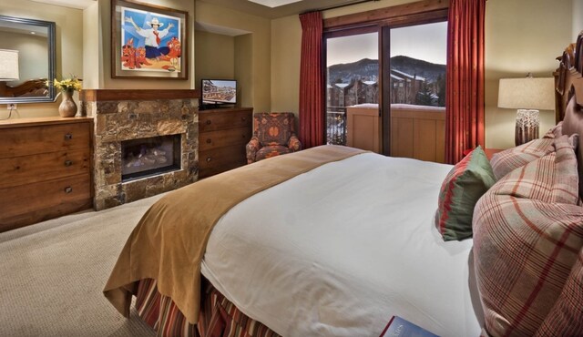 2250 Apres Ski Way Unit R-702, Steamboat Springs, CO 80487 - bedroom with a fireplace and carpet