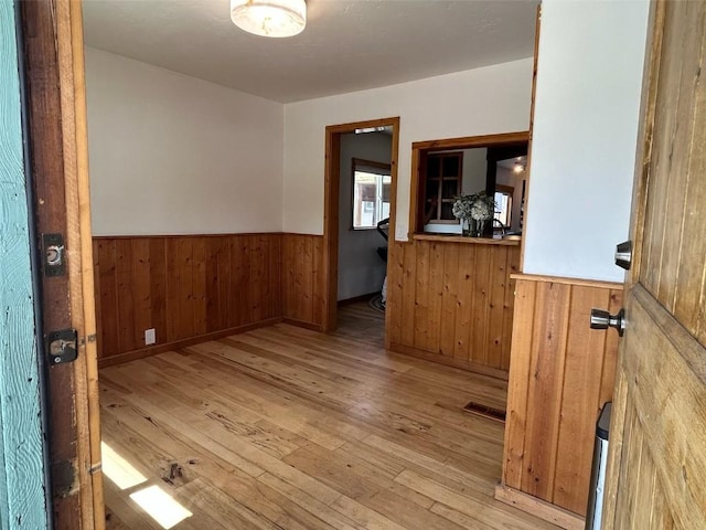 1325 Dream Island Plz Unit 55, Steamboat Springs, CO 80487 - empty room featuring wainscoting, wood-type flooring, and wood walls