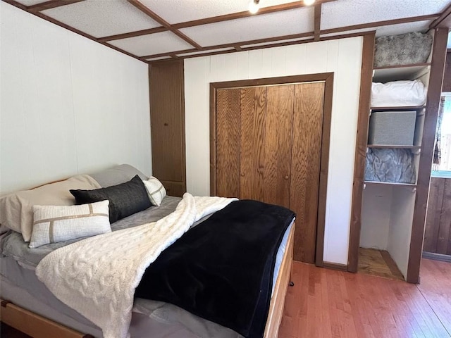 1325 Dream Island Plz Unit 55, Steamboat Springs, CO 80487 - bedroom featuring wood-type flooring and wood walls