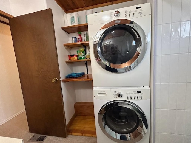 1325 Dream Island Plz Unit 55, Steamboat Springs, CO 80487 - laundry room with stacked washing machine and dryer and carpet