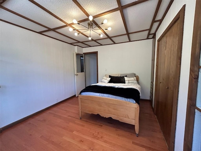 1325 Dream Island Plz Unit 55, Steamboat Springs, CO 80487 - bedroom featuring wood finished floors and a chandelier