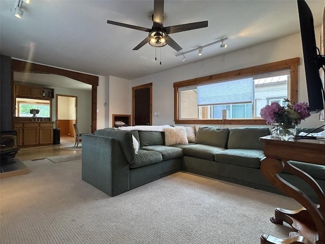 1325 Dream Island Plz Unit 55, Steamboat Springs, CO 80487 - living room with track lighting, plenty of natural light, ceiling fan, and a wood stove